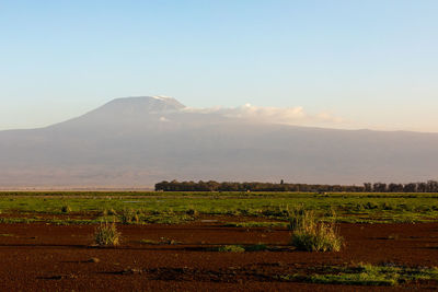 Scenic view of field against sky during sunset