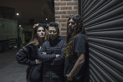 Band posing for portrait on a street at night