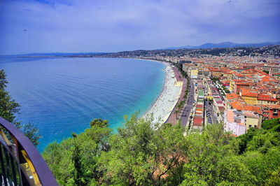 High angle view of townscape by sea against sky