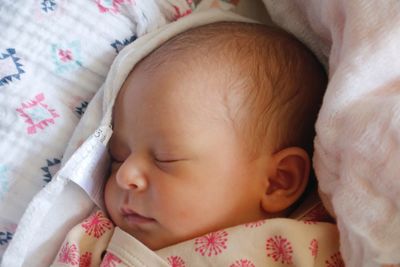 High angle view of baby sleeping on bed