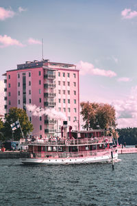 Boats in front of buildings against sky