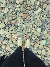 Low section of person standing on stones