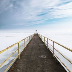 Pier over sea against sky