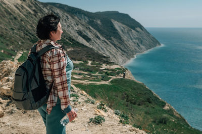 Rear view of man standing on mountain