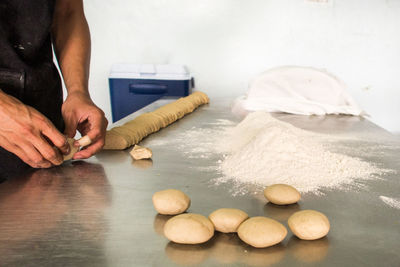 Cropped image of man preparing food on table