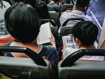 Rear view of people sitting in bus