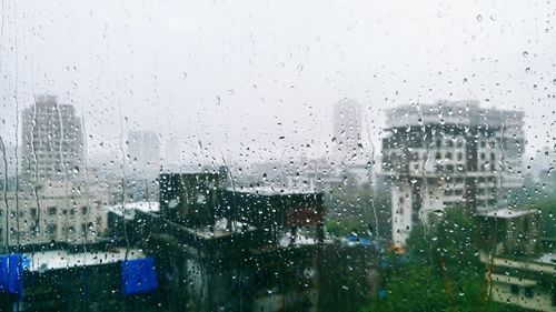 Buildings seen through wet window in rainy season
