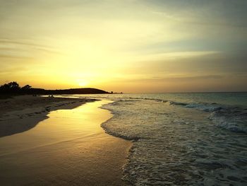 Scenic view of beach against sky during sunset