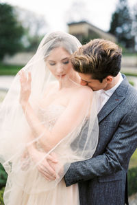 Side view of couple standing in park