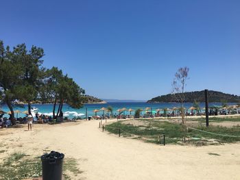 Scenic view of beach against clear blue sky