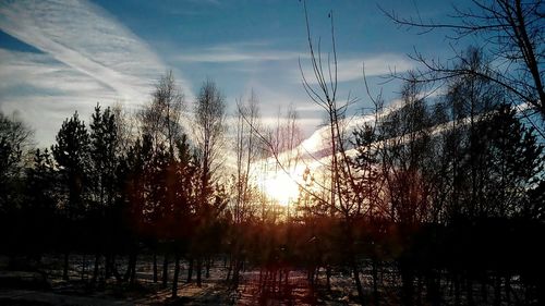 Scenic view of river against sky at sunset