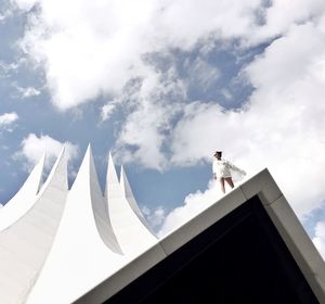 Low angle view of building against cloudy sky