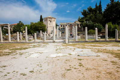 Tourists visiting the ancient ruins at the roman agora in the acropolis in athens