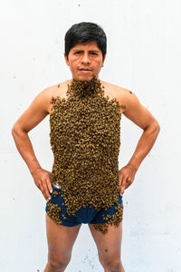 Portrait of woman standing against white background