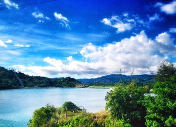 Scenic view of lake and mountains against sky