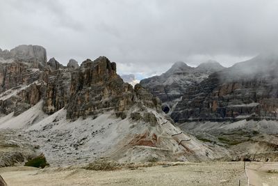 Scenic view of mountains against cloudy sky