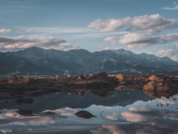 Scenic view of lake and mountains against sky