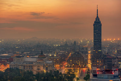 Torre latinoamericana amidst buildings in city at sunset