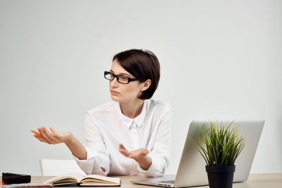 Businesswoman having discussion while sitting at office