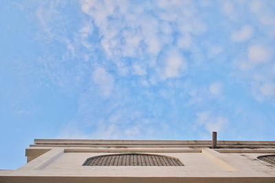 Low angle view of building against cloudy sky