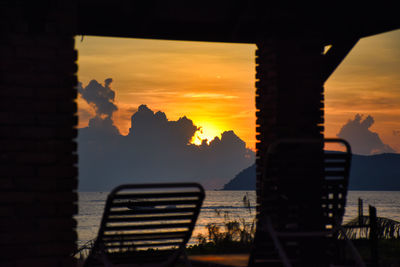 Amazing wonderful dramatic golden colored sky behind the clouds during a stunning sunset in langkawi