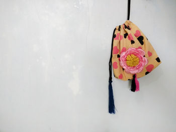 Close-up of pink flower hanging on wall