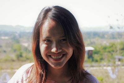 Close-up portrait of a smiling young woman