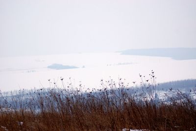 Scenic view of sea against sky during winter