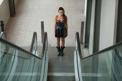 Young woman at escalator