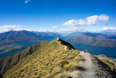 Scenic view of mountains against blue sky