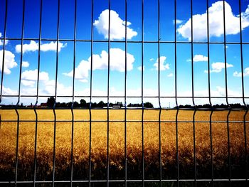 Scenic view of field seen through fence