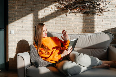 Woman relaxing on sofa at home