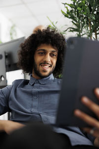 Portrait of young woman using laptop at home