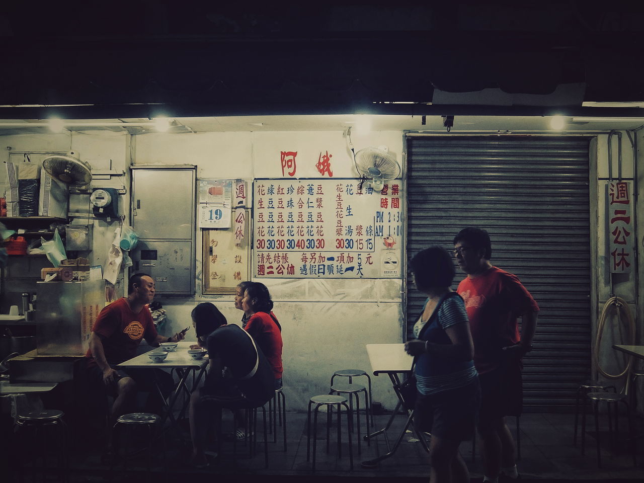 real people, men, indoors, standing, chair, sitting, artist, women, architecture, night, built structure, occupation, full length, illuminated, working, city, people