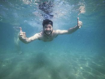 Portrait of man swimming in sea