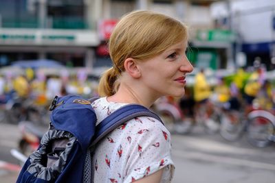 Side view of woman looking away outdoors