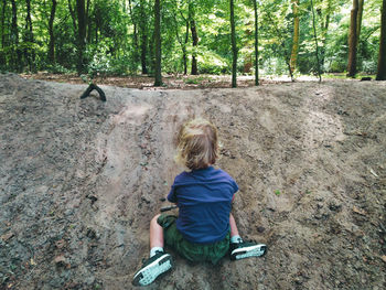 Rear view of boy in forest