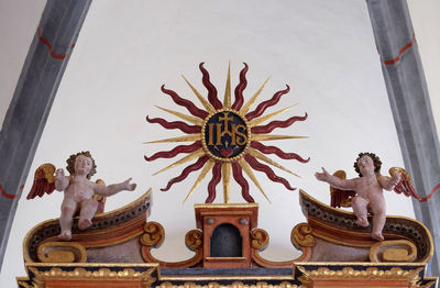 Low angle view of statue against temple building