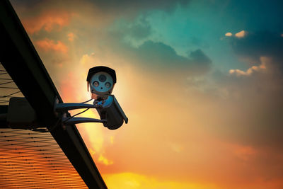 Low angle view of silhouette lamp against sky during sunset