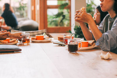 People eating food on table in restaurant