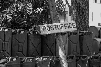 Close-up of information sign against trees