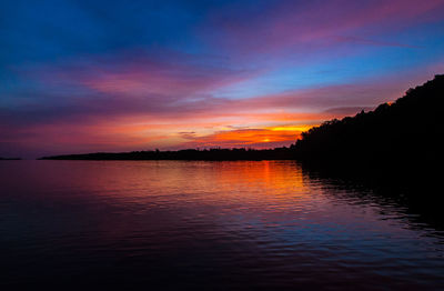 Scenic view of lake against romantic sky at sunset