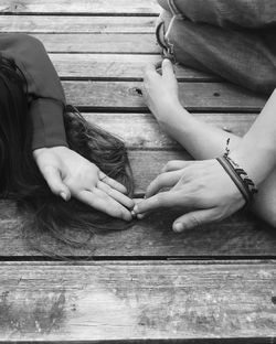 Low angle view of woman hands on wood