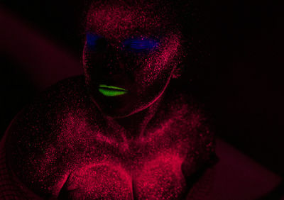 Woman with eyes closed in neon make-up