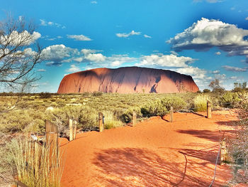 Scenic view of sand dunes against sky