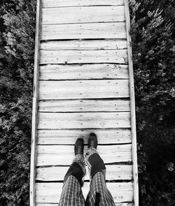 Low section of person standing on boardwalk