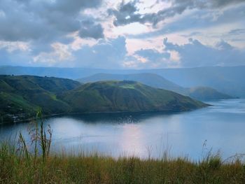 Scenic view of lake and mountains against sky