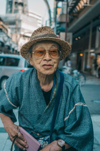 Portrait of mature man using mobile phone in city