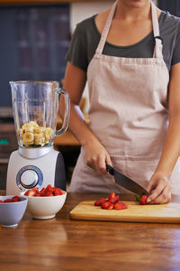 Midsection of man preparing food on table