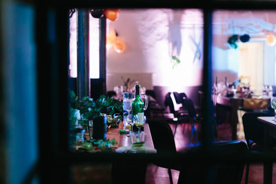 Glass of bottles on table at restaurant